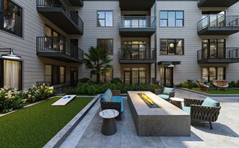 Fire place and cornhole in outdoor courtyard