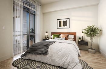A bedroom with a bed and a sliding glass door to a balcony
