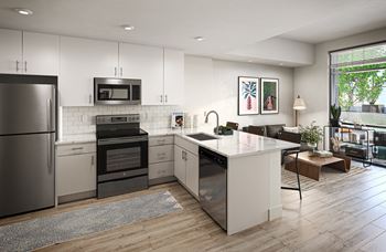 A kitchen with white cabinets and stainless steel appliances