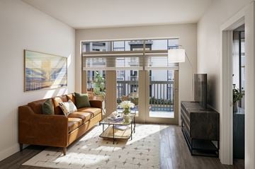 Smyrna apartment for rent - A living room with a brown couch and a painting on the wall.