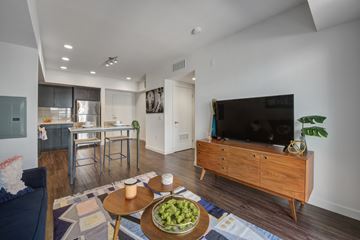 Los Angeles apartment for rent - A modern living room with a wooden coffee table and a flat screen TV.