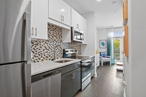 Charlotte apartment for rent - Studio kitchen with stainless steel appliances and quartz counters at Link Apartments® Mint Street in Uptown Charlotte, NC. at Link Apartments® Mint Street, Charlotte, NC, 28203