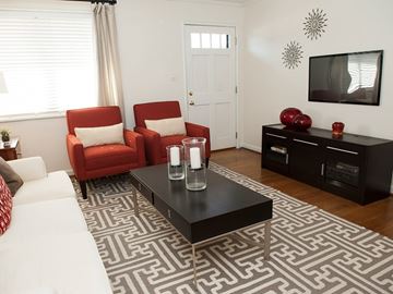 Chapel Hill apartment for rent - A living room with a black coffee table and red chairs.
