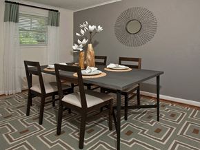 Chapel Hill apartment for rent - A dining room with a table set for two and a vase of white flowers.