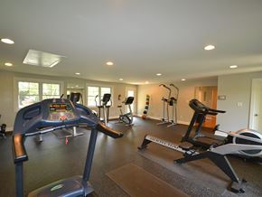 Chapel Hill apartment for rent - A gym with a treadmill, exercise bike, and other equipment.