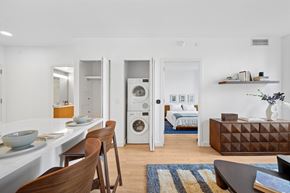 Long Island City apartment for rent - A modern kitchen with a dining table and chairs.at Link Apartments® QPN, Long Island City New York