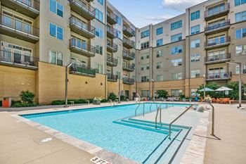 A swimming pool in front of an apartment building