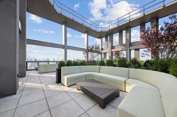 Patio with a table and a white bench