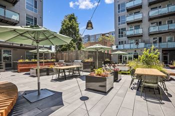 A patio with tables and chairs and umbrellas