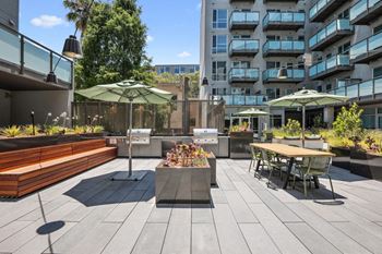 A rendering of a patio with tables and umbrellas