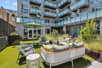 An outdoor patio with furniture and a table and chairs