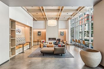 The lobby of a building with a living room and a fireplace
