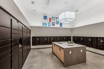 A large locker room with wooden cabinets and a table with a plant