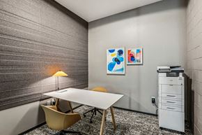 Oakland apartment for rent - a conference room with a table and chairs and a filing cabinet at Link Apartments® Four 12, Oakland, 94607