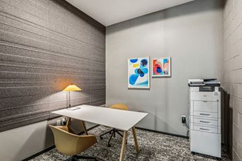 A conference room with a table and chairs and a filing cabinet
