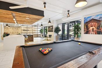 A pool table in a game room