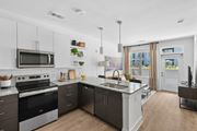 Smyrna apartment for rent - Contemporary kitchen with island and pendant lights at Link ® Lake Park Apartments, Smyrna, GA
