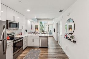 Oakland apartment for rent - a large kitchen with white cabinets and stainless steel appliances at Link Apartments® Four 12, Oakland, CA