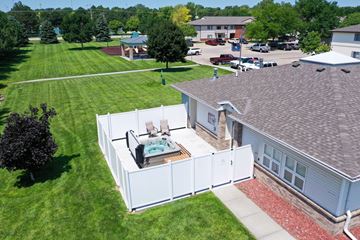 Kearney apartment for rent - A hot tub is on a deck outside a house.