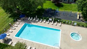 Evans apartment for rent - An aerial view of a swimming pool surrounded by lounge chairs and trees.