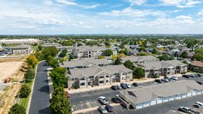 Evans apartment for rent - A parking lot is in front of a building.at Crescent Cove Apartments, Evans Colorado