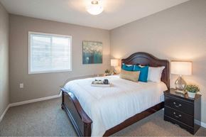 Loveland apartment for rent - a bedroom with a large bed and a window