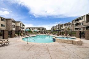 Evans apartment for rent - A swimming pool surrounded by a fence and chairs in a residential area.