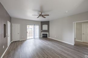 North Las Vegas apartment for rent - A spacious room with a ceiling fan and wooden flooring. at Cheyenne Villas, North Las Vegas, NV