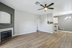North Las Vegas apartment for rent - A living room with a fireplace and a ceiling fan.