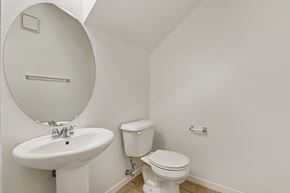 North Las Vegas apartment for rent - A white toilet sits next to a sink in a small bathroom. at Rome Park Villas, North Las Vegas