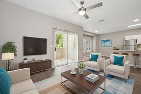 Chandler apartment for rent - A living room with a white couch, a wooden coffee table, and a flat screen TV.