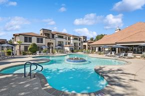 Phoenix apartment for rent - a swimming pool with a fountain in front of a building