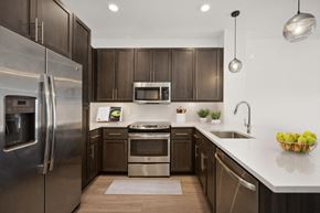Phoenix apartment for rent - a kitchen with stainless steel appliances and wooden cabinets