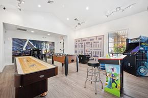 Tempe apartment for rent - Resident social lounge with a shuffleboard table and a pool table.