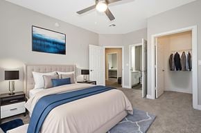 Chandler apartment for rent - A bedroom with a large bed and a ceiling fan.