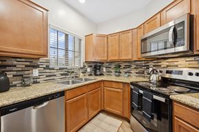 Scottsdale apartment for rent - A kitchen with wooden cabinets and a granite countertop.