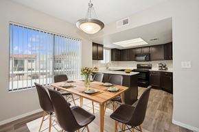 Phoenix apartment for rent - A modern dining room with a wooden table and chairs.