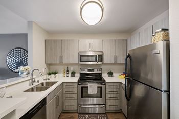 Stainless steel appliances including built-in microwave, refrigerator, and dishwasher