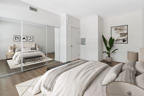 San Diego apartment for rent - a bedroom with a large bed and a mirror