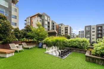 Open green space with bocce ball and oversized chess