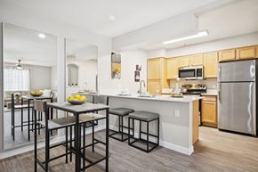 Tempe apartment for rent - A kitchen with a table and chairs in front of a mirror.