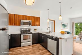Lynnwood apartment for rent - A modern kitchen with a wooden backsplash and stainless steel appliances.