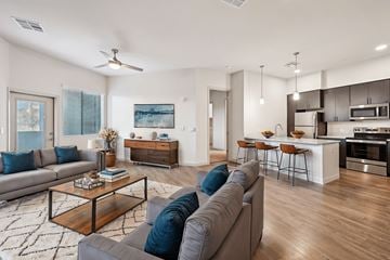 Tempe apartment for rent - A modern living room with a grey sofa and a wooden coffee table.