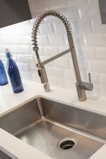 Large under-mount kitchen sinks with designer faucet hardware