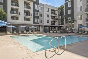 Woodland Hills apartment for rent - a swimming pool in front of an apartment building