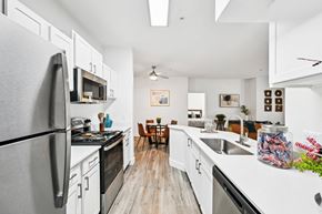 Aurora apartment for rent - A kitchen with black appliances and white cabinets.