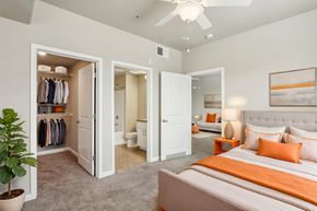 Sacramento apartment for rent - A bedroom with a bed, a wardrobe, and a potted plant.