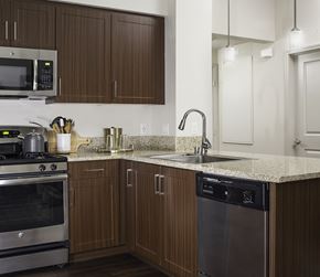 Vista apartment for rent - A kitchen with brown cabinets and a granite countertop.