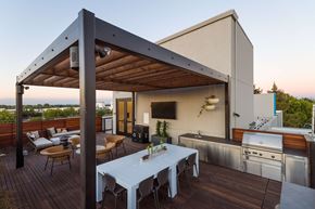 Sacramento apartment for rent - A modern outdoor kitchen with a dining table and chairs.