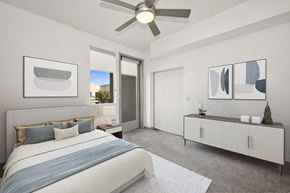 Phoenix apartment for rent - a bedroom with a large bed and a ceiling fan